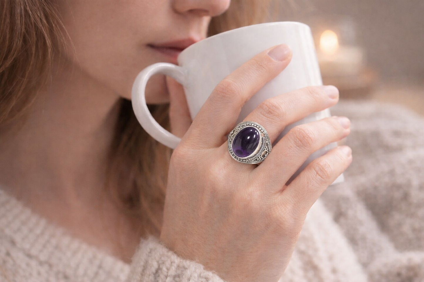 Bague en argent et améthyste au doigt d'une femme en train de boire une tasse de thé