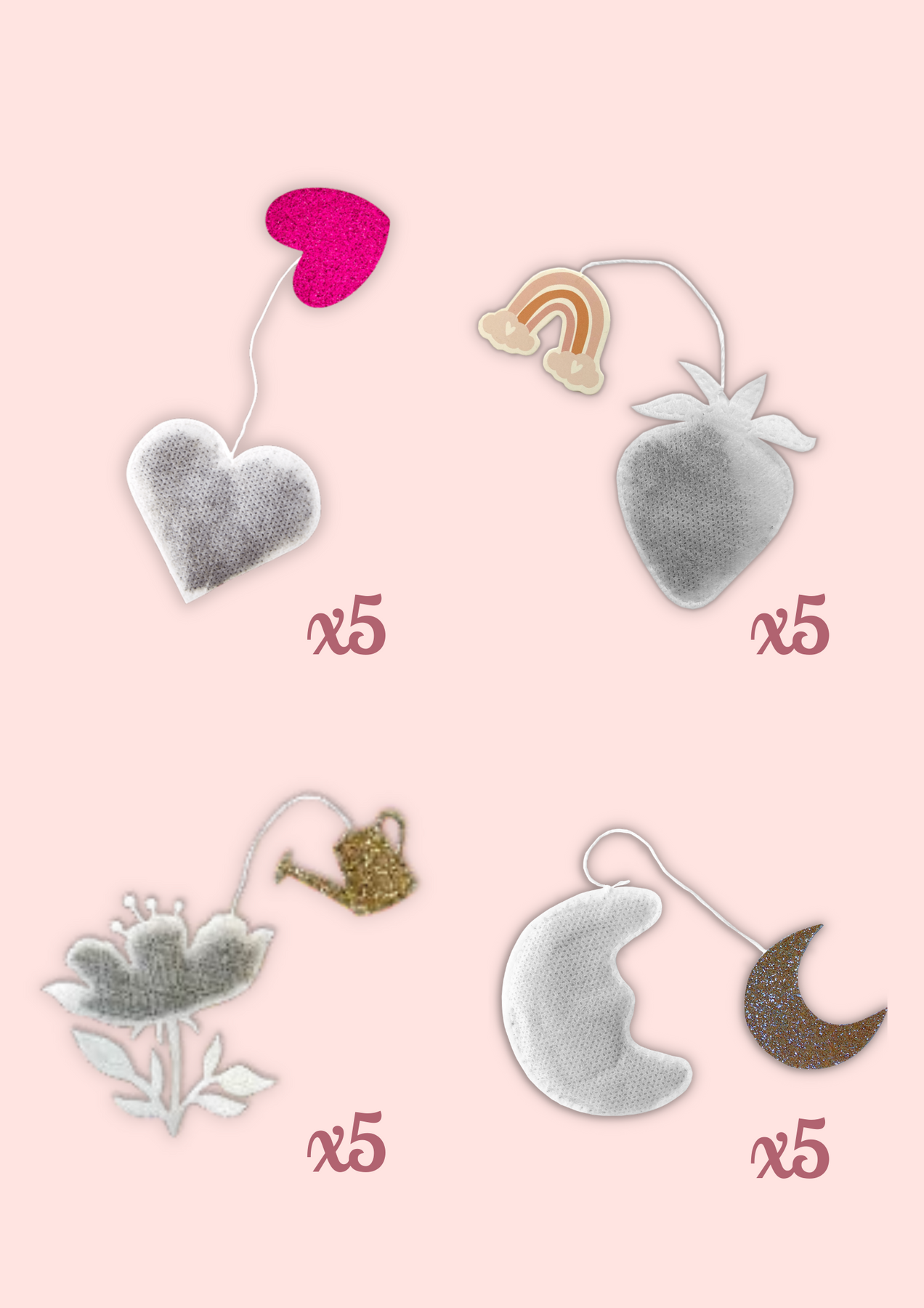 Visuel de la compositions intérieur d'un coffret rose de sachets de thé en formes de coeur, de lune, de fleur et de fraise