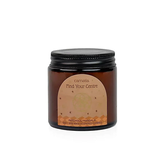 Bougie Carnatia Find Your Centre en pot en verre ambré avec couvercle noir, étiquette Patchouli Mandala, sur fond blanc