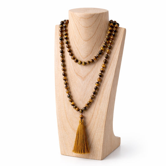 Collier mala perles oeil de tigre et pompon en coton marron, sur présentoir bois clair
