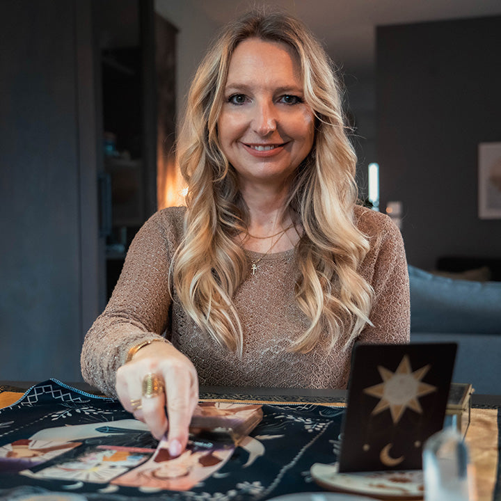 Femme blonde tirant les cartes oracles, tapis de divination